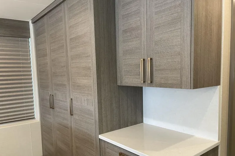 Slide: The Image of Modern wooden cabinets with sleek handles in a minimalist interior design. - 13