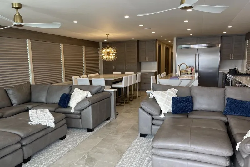 Slide: The Image of Modern RV interior with gray sofas, dining area, and kitchen in Adonia Max'd Out Trip 2021. - 15