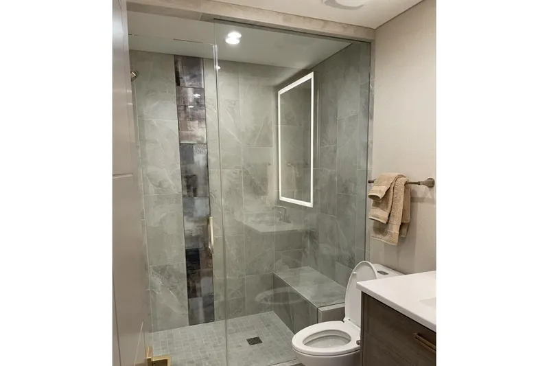 Slide: The Image of Modern bathroom with glass shower, tiled walls, and sleek fixtures in Adonia Max'd Out Trip model. - 3