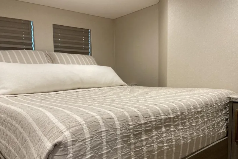 Slide: The Image of Cozy bedroom in Adonia Max'd Out Trip 7A & 7B, 2021 model, with striped bedding. - 9