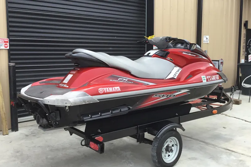 Slide: The Image of 2010 Yamaha FX SHO jet ski on trailer, parked in front of a garage. - 4