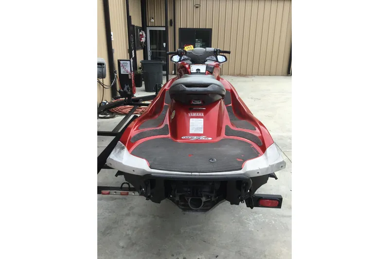 Slide: The Image of 2010 Yamaha FX SHO jet ski, red, parked on concrete near a building. - 6