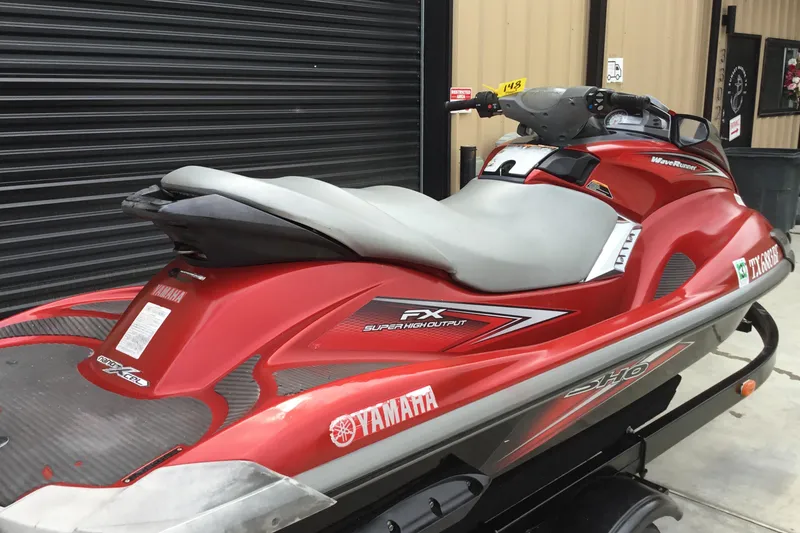Slide: The Image of 2010 Yamaha FX SHO jet ski in red, parked indoors on a trailer. - 7