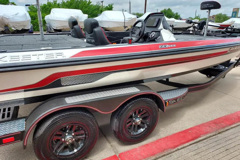 Slide: The Image of 2021 Skeeter ZX200 boat on trailer, featuring sleek design and dual wheels. - 2