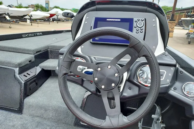 Slide: The Image of 2021 Skeeter ZX200 boat dashboard with steering wheel and Humminbird display. - 7