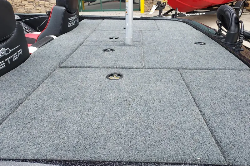 Slide: The Image of 2021 Skeeter ZX200 boat deck with gray carpet and storage compartments. - 9