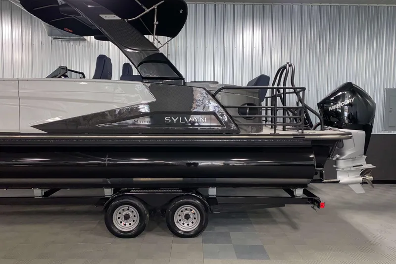 Slide: The Image of 2025 Sylvan M3 DLZ DH Tritoon boat with Mercury engine on trailer in showroom. - 18