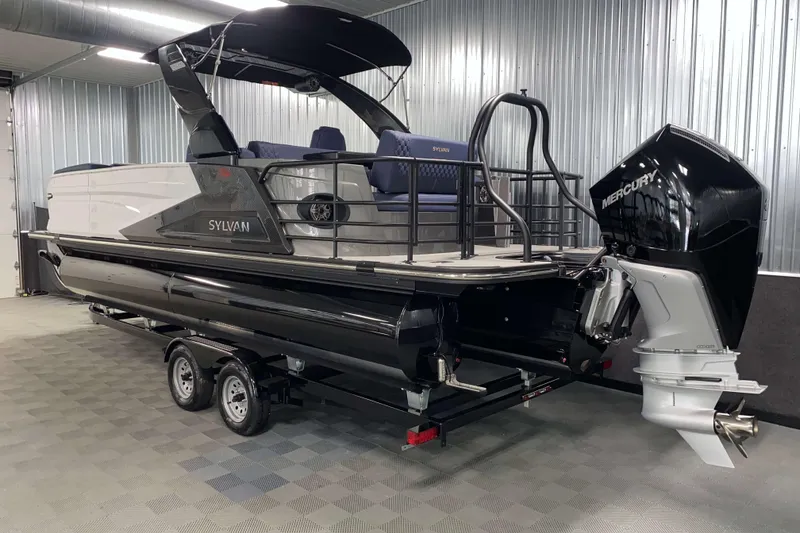 Slide: The Image of 2025 Sylvan M3 DLZ DH Tritoon boat with Mercury outboard engine in a showroom. - 19