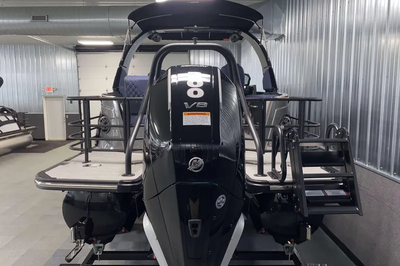 Slide: The Image of 2025 Sylvan M3 DLZ DH Tritoon with powerful V8 engine in a modern showroom. - 20