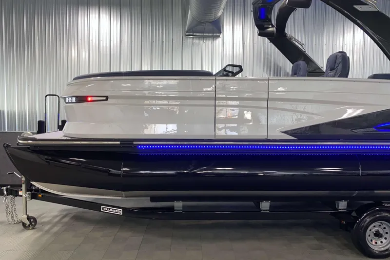 Slide: The Image of 2025 Sylvan M3 DLZ DH Tritoon boat with sleek design and blue LED lighting. - 23