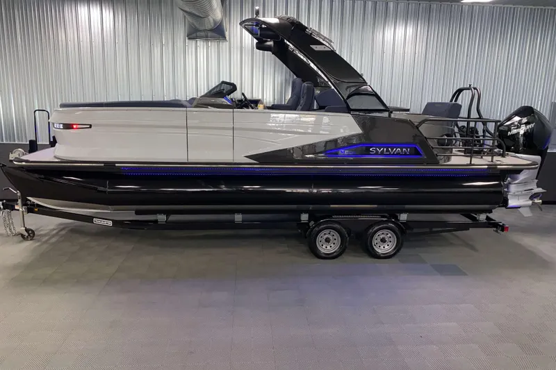 Slide: The Image of 2025 Sylvan M3 DLZ DH Tritoon boat on trailer in showroom. - 24