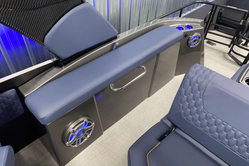 Slide: The Image of Interior of 2025 Sylvan M3 DLZ DH Tritoon with blue seating and modern speaker system. - 30