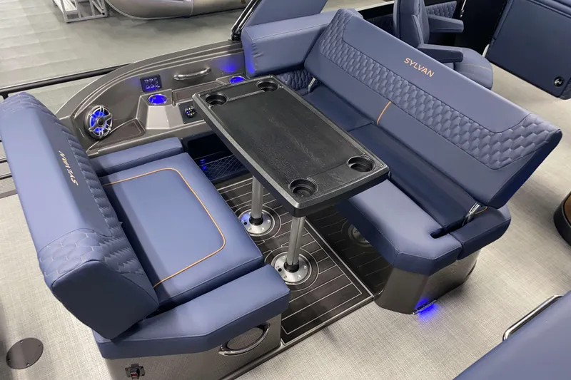 Slide: The Image of Luxurious seating area on 2025 Sylvan M3 DLZ DH Tritoon with table and cup holders. - 31