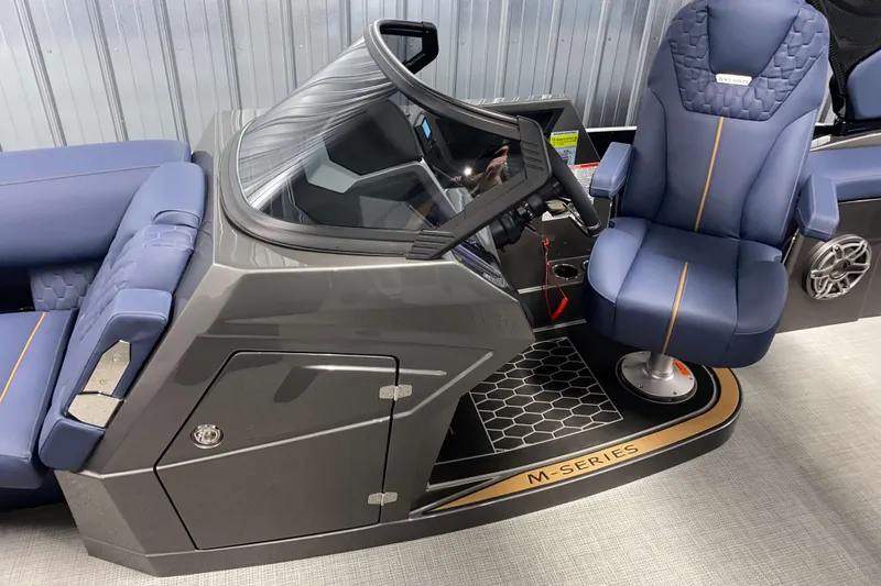 Slide: The Image of 2025 Sylvan M3 DLZ DH Tritoon interior with blue captain's chair and modern dashboard. - 7