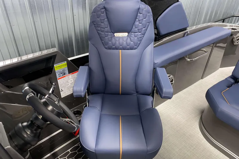 Slide: The Image of Captain's chair in 2025 Sylvan M3 DLZ DH Tritoon boat, featuring sleek blue upholstery. - 8