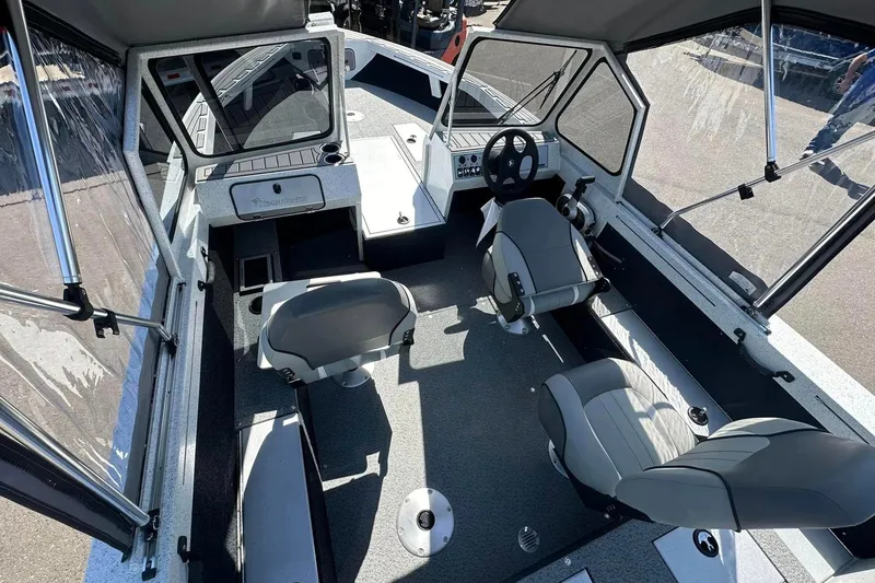 Slide: The Image of Interior of 2026 KingFisher 1825 Warrior Sport boat with modern seating and controls. - 4