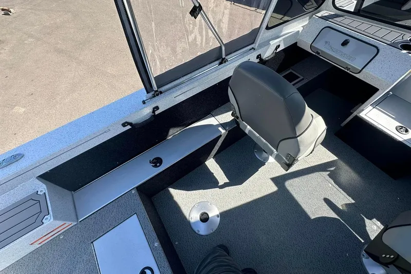 Slide: The Image of Interior of 2026 KingFisher 1825 Warrior Sport boat, featuring seating and storage compartments. - 6