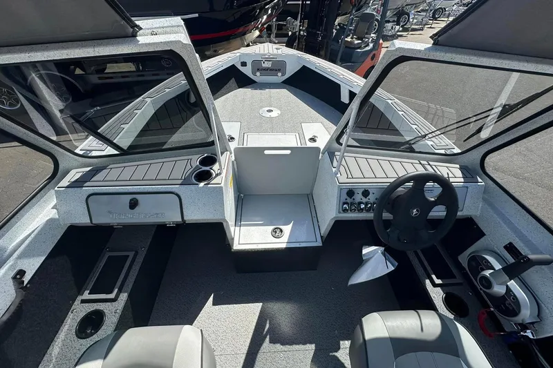 Slide: The Image of Interior view of 2026 KingFisher 1825 Warrior Sport boat, featuring modern controls and seating. - 7