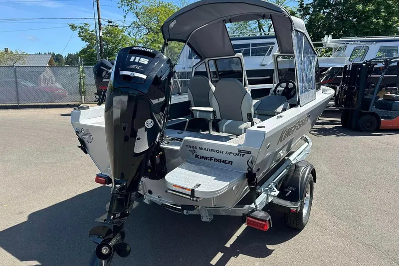 Slide: The Image of 2026 KingFisher 1825 Warrior Sport boat with Mercury 115 engine, parked outdoors. - 8