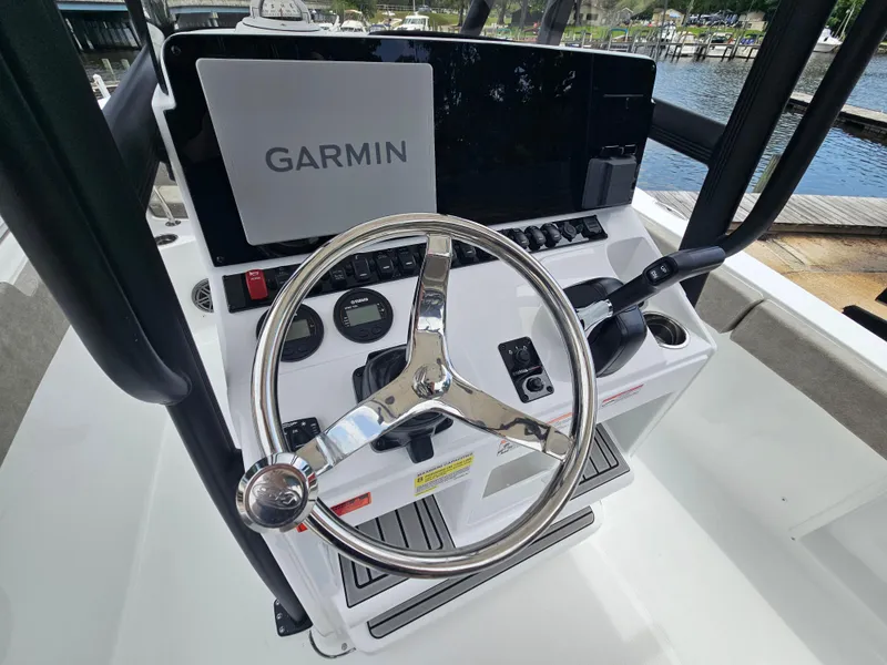 Slide: The Image of 2025 Sea Hunt Ultra 219 boat dashboard with Garmin navigation system and steering wheel. - 10