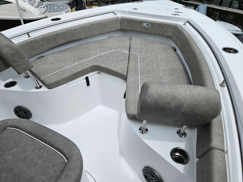 Slide: The Image of 2025 Sea Hunt Ultra 219 boat interior with gray cushioned seating and sleek design. - 16