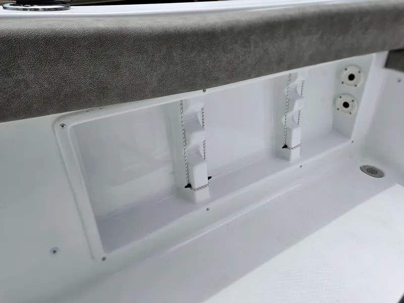 Slide: The Image of Interior detail of 2025 Sea Hunt Ultra 219 boat, featuring storage compartments and utility outlets. - 21