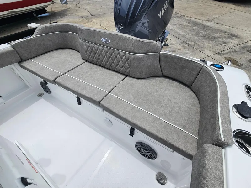 Slide: The Image of 2025 Sea Hunt Ultra 219 boat with cushioned seating and Yamaha engine. - 6