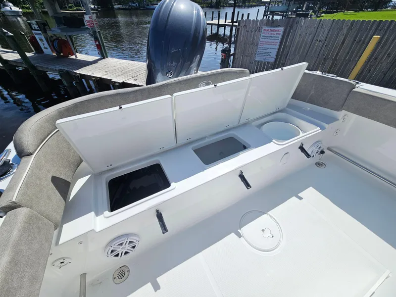 Slide: The Image of 2025 Sea Hunt Ultra 219 boat interior with open storage compartments and seating. - 7