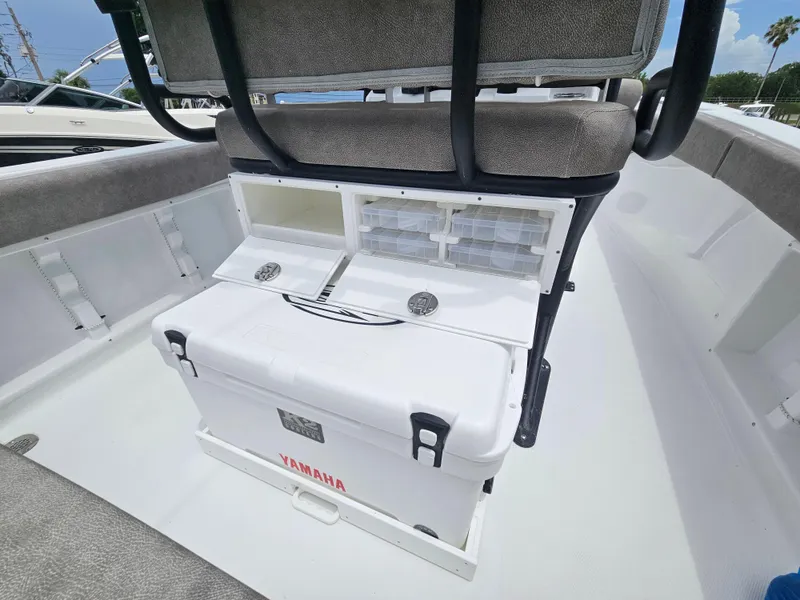 Slide: The Image of 2025 Sea Hunt Ultra 219 boat interior with Yamaha cooler and storage compartments. - 9