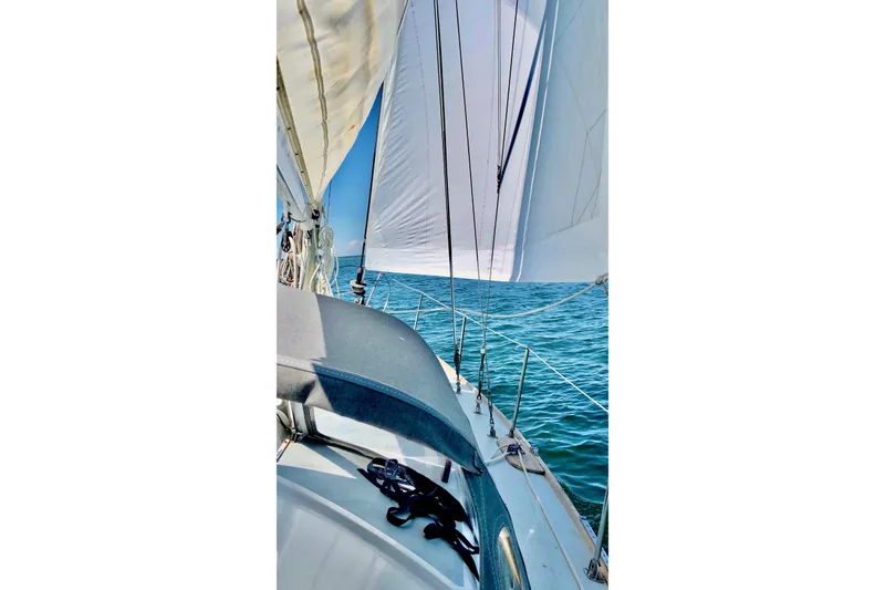 Slide: The Image of Sailing on a 1971 Pearson Competitor yacht with white sails over blue ocean. - 2