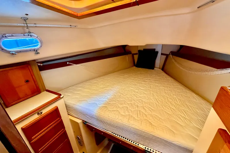 Slide: The Image of Cozy cabin interior of a 1971 Pearson Competitor sailboat with a comfortable bed and wooden cabinetry. - 13