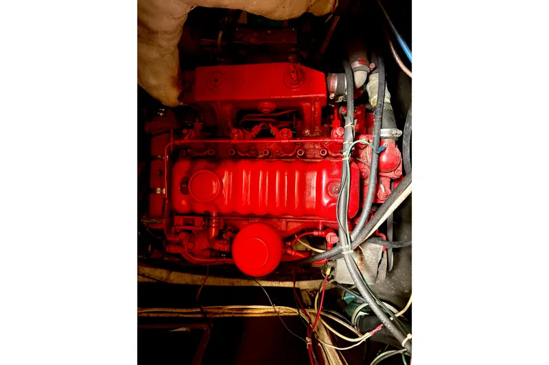 Slide: The Image of Red engine of a 1971 Pearson Competitor boat with visible wiring and components. - 5