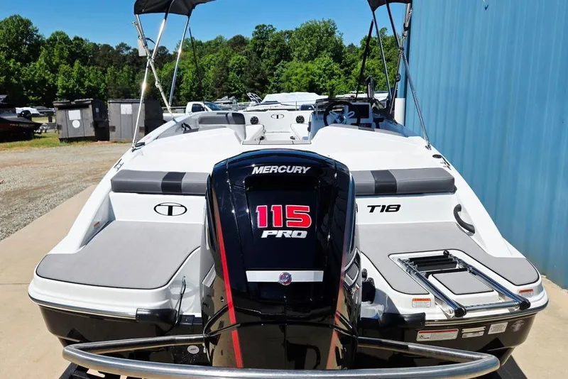 Slide: The Image of 2026 Tahoe T18 boat with Mercury 115 Pro engine, docked outdoors. - 11