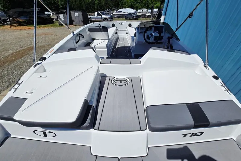 Slide: The Image of 2026 Tahoe T18 boat with sleek white and gray design, docked outdoors. - 14