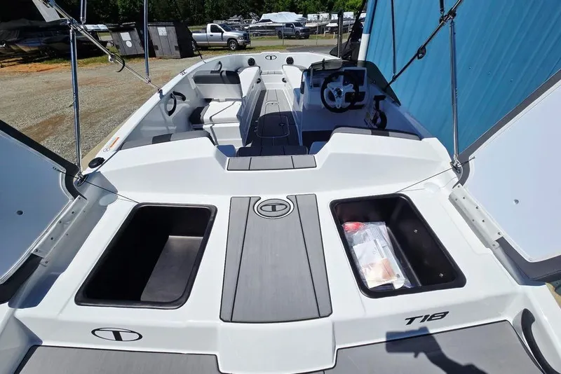 Slide: The Image of 2026 Tahoe T18 boat interior with storage compartments and steering wheel. - 15