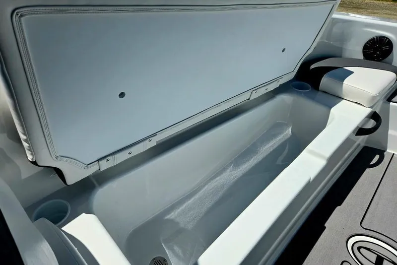 Slide: The Image of 2026 Tahoe T18 boat storage compartment with open lid, showcasing spacious interior design. - 18