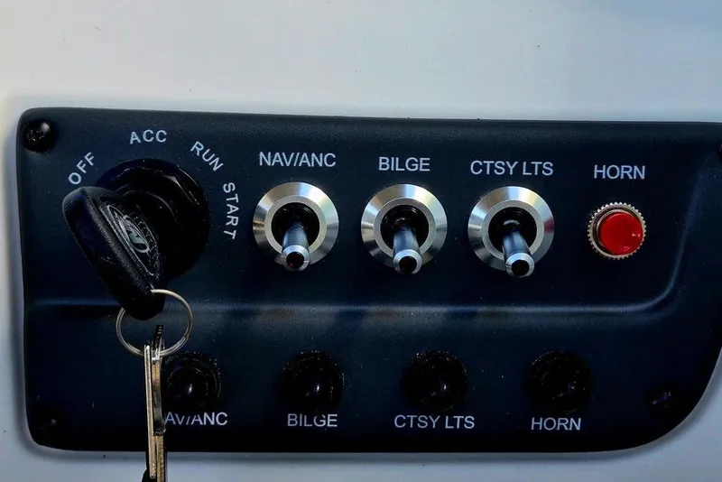 Slide: The Image of Control panel of a 2026 Tahoe T18 boat with ignition and switches. - 29