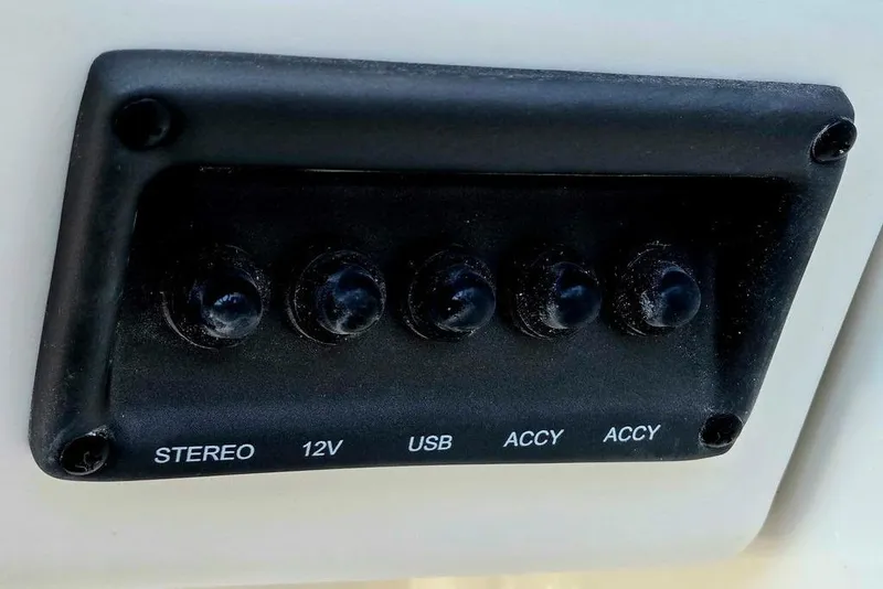 Slide: The Image of Control panel with stereo, 12V, USB, and accessory switches on a 2026 Tahoe T18. - 34
