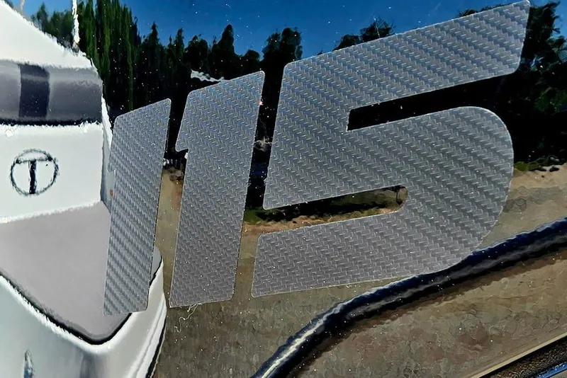 Slide: The Image of Close-up of Tahoe T18 2026 model with '115' decal on reflective surface. - 8