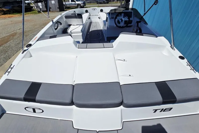 Slide: The Image of 2026 Tahoe T18 boat with spacious seating and modern design, docked outdoors. - 9