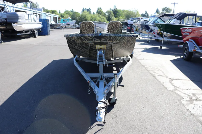 Slide: The Image of 2026 Smoker Craft Sportsman 1660 boat on trailer in outdoor showroom. - 4