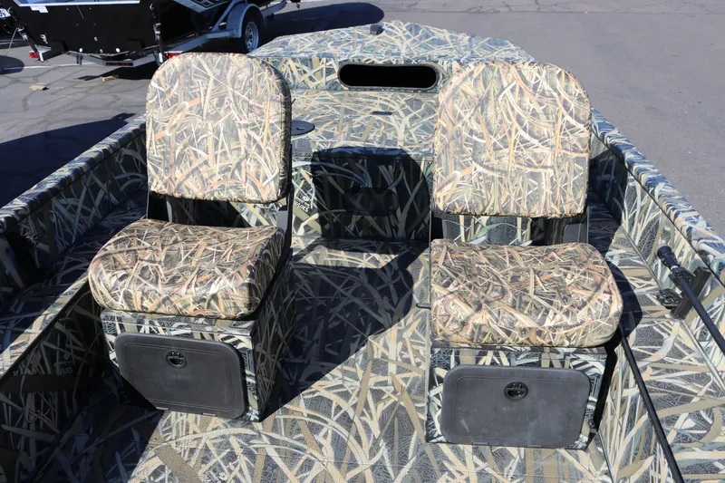 Slide: The Image of 2026 Smoker Craft Sportsman 1660 boat with camouflage seating and storage compartments. - 5