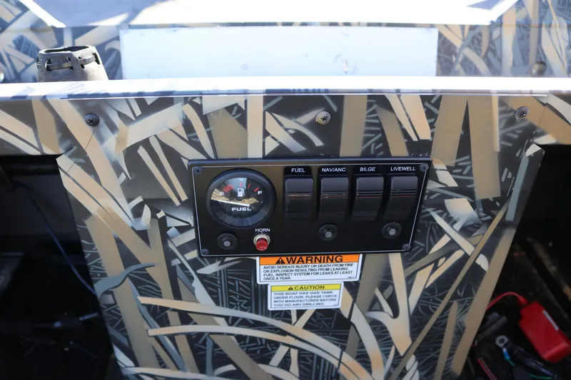 Slide: The Image of Control panel of 2026 Smoker Craft Sportsman 1660 boat with camouflage design. - 9