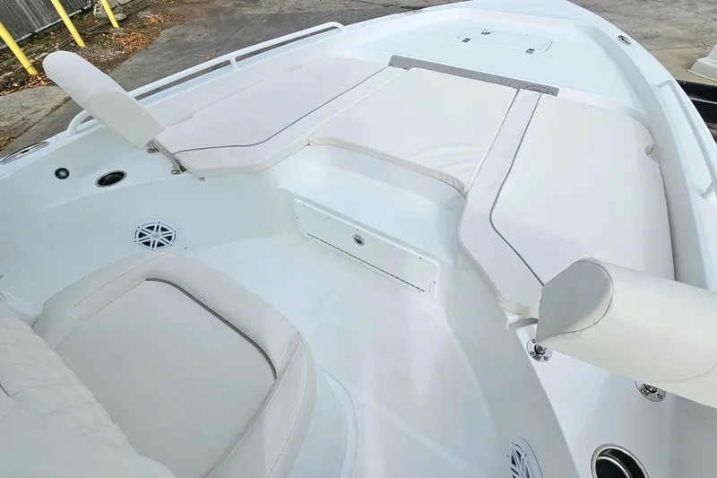 Slide: The Image of 2026 Sea Hunt BX 25 FS boat interior with white cushioned seating and storage compartments. - 18
