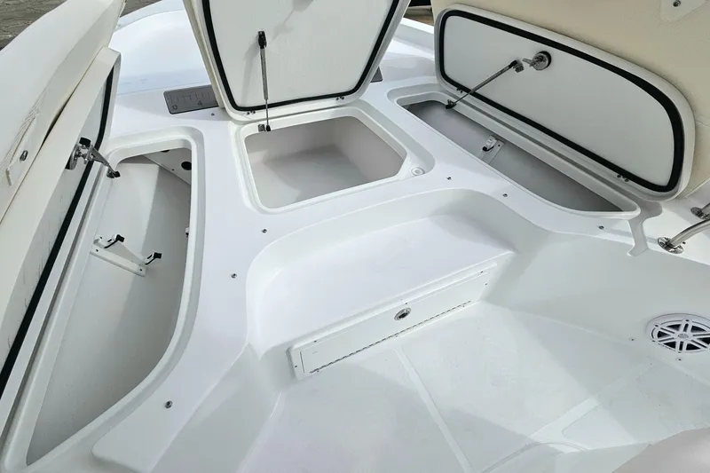 Slide: The Image of 2026 Sea Hunt BX 25 FS boat storage compartments open, showcasing spacious interior design. - 19