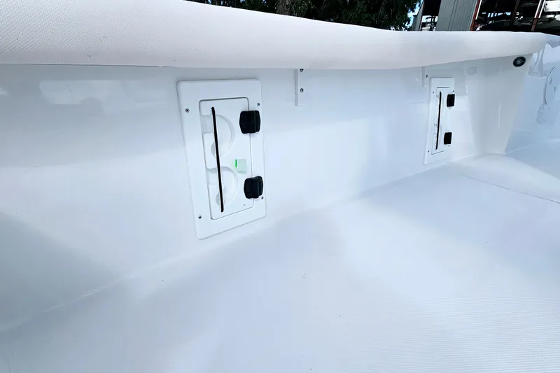 Slide: The Image of 2026 Sea Hunt BX 25 FS boat interior with storage compartments and sleek white finish. - 23