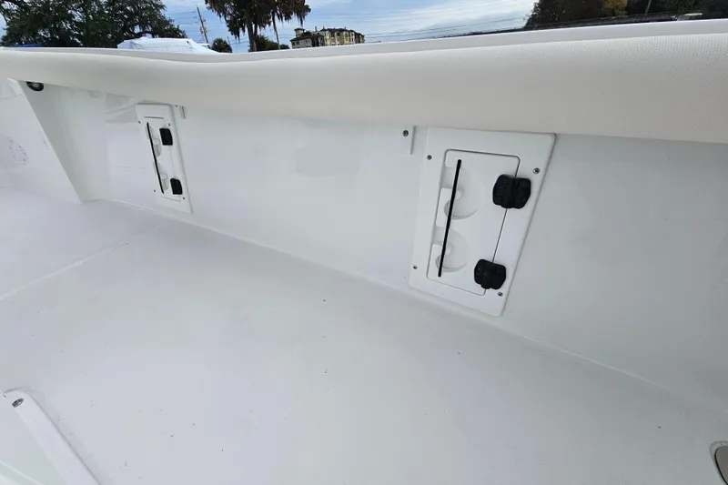 Slide: The Image of 2026 Sea Hunt BX 25 FS boat interior with storage compartments and sleek white finish. - 24