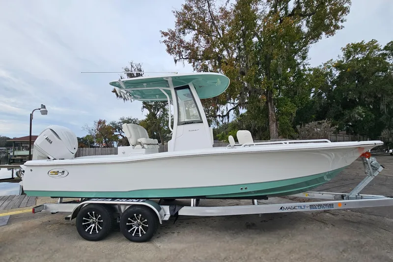 Slide: The Image of 2026 Sea Hunt BX 25 FS boat on trailer, parked outdoors near trees. - 3