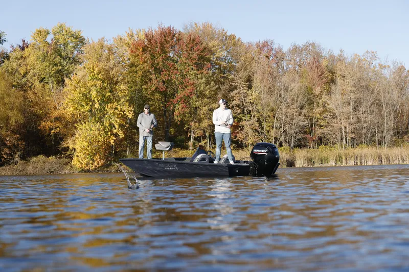 Slide: The Image of Two people fishing on a 2026 Smoker Craft Viper XR 165 boat in autumn scenery. - 3
