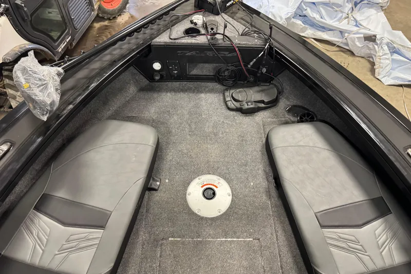 Slide: The Image of Interior of 2026 Tracker Targa V-19 Combo boat with seating and control panel. - 13